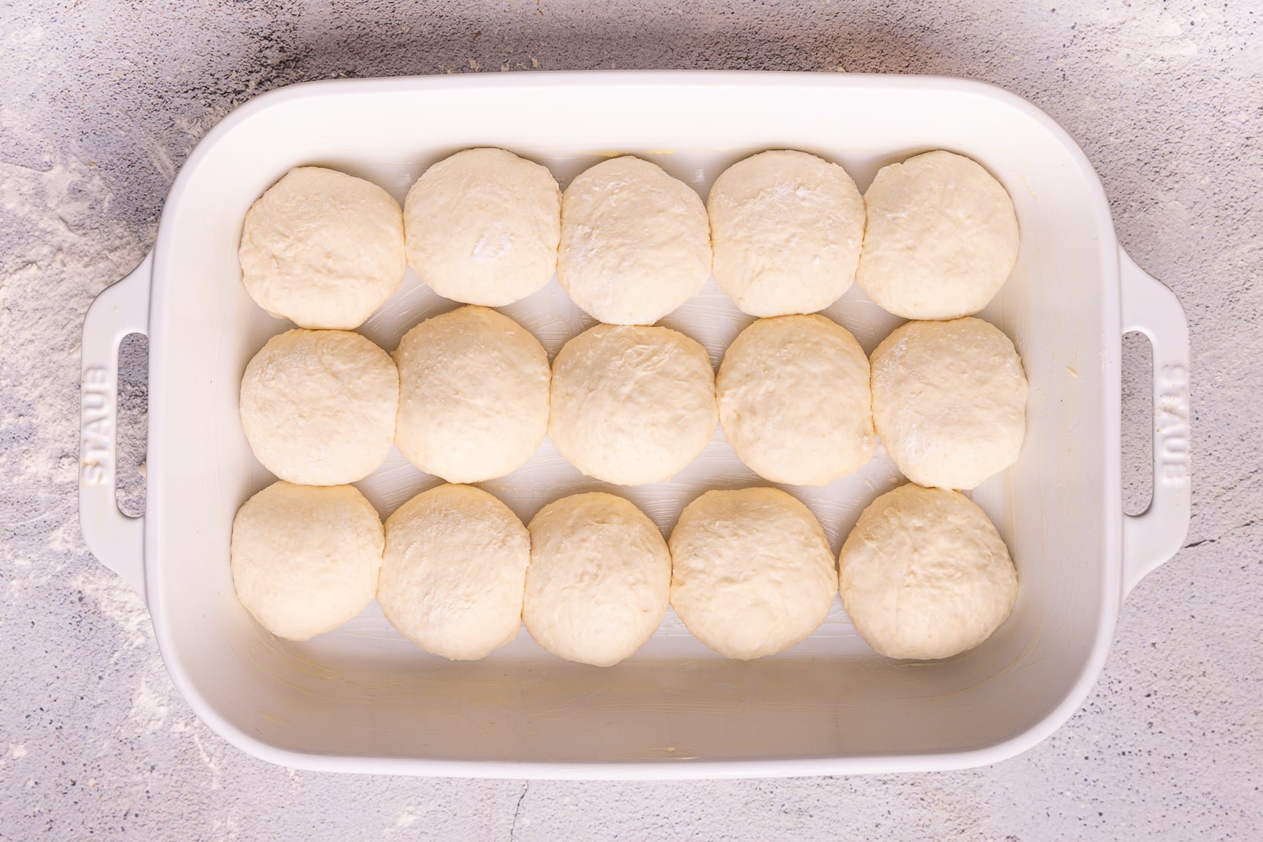 balls of dough in a ceramic baking dish