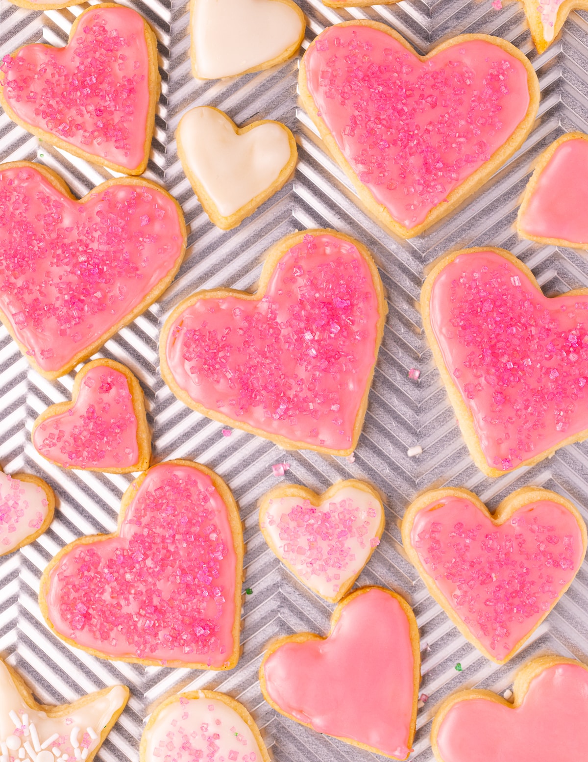 heart shaped vegan sugar cookies on a baking tray