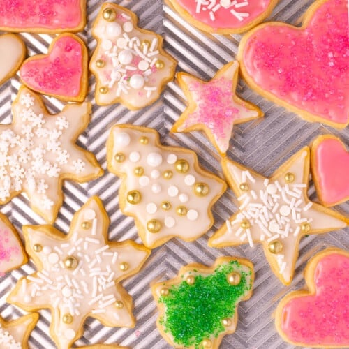 iced and decorated vegan sugar cookies on a baking tray