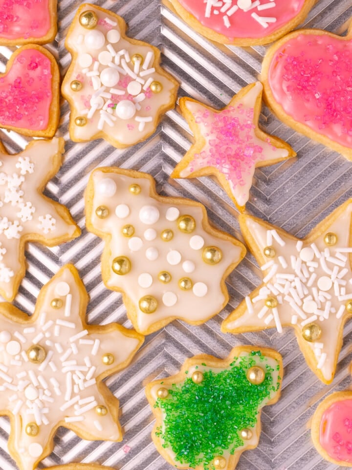 iced and decorated vegan sugar cookies on a baking tray