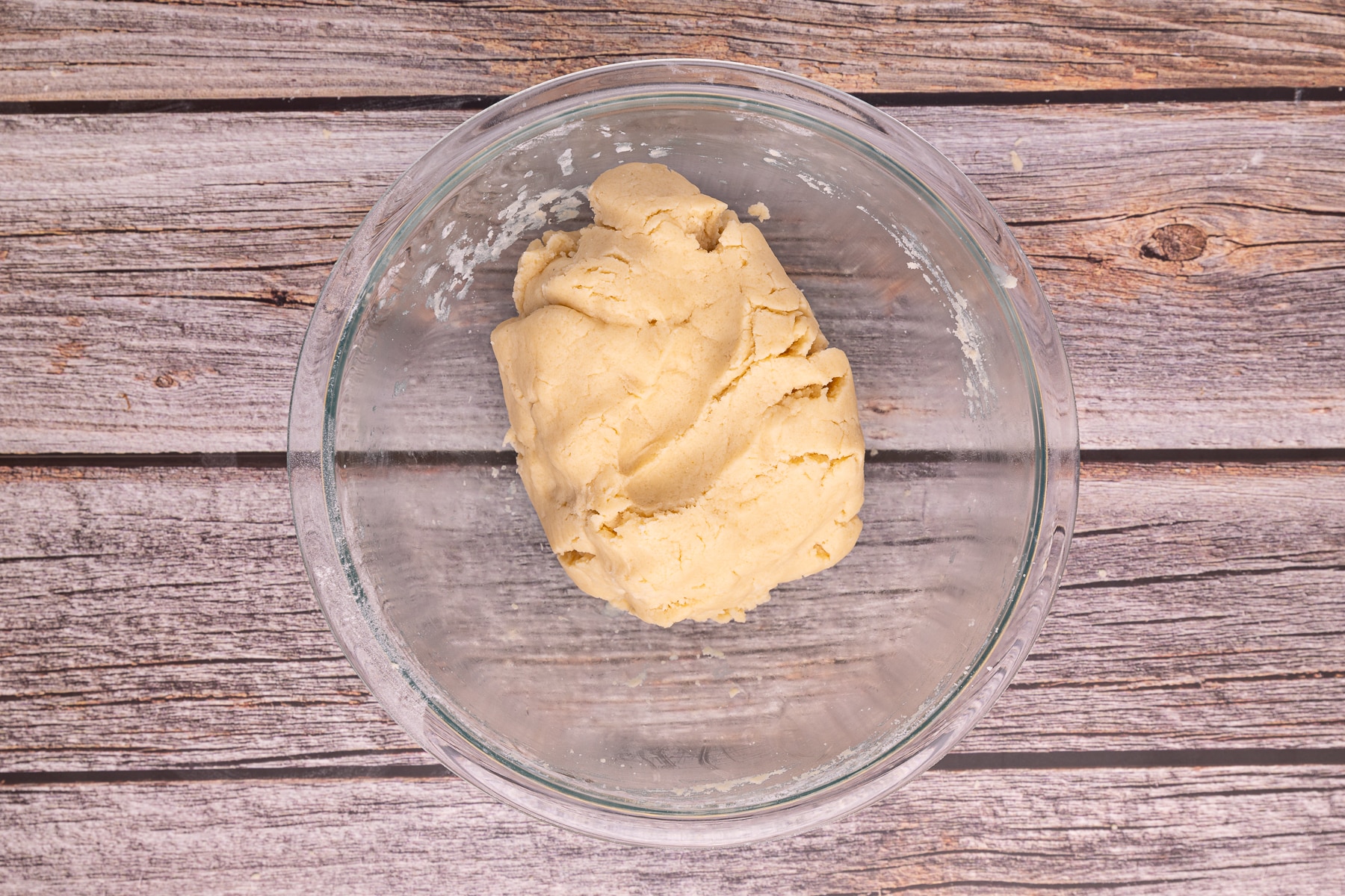 a ball of cookie dough in a mixing bowl