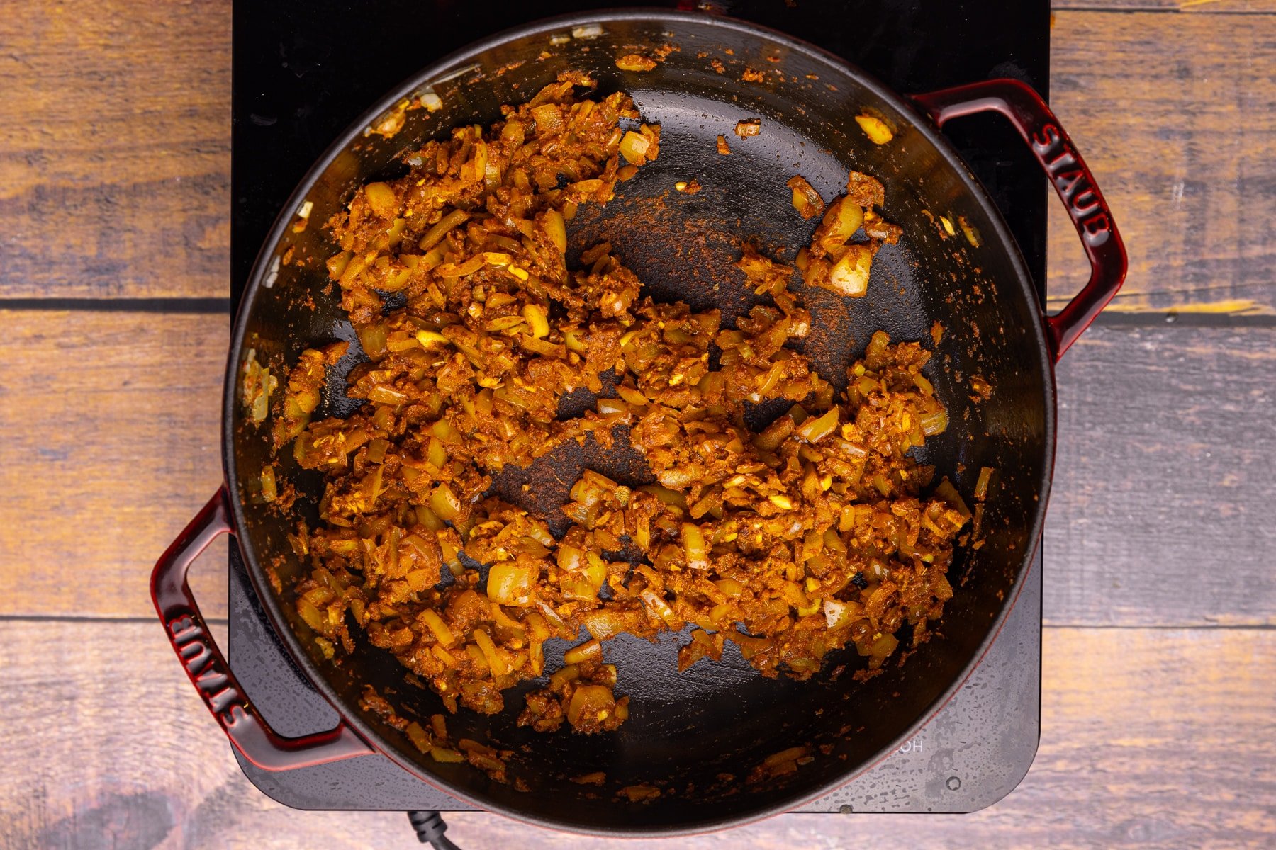 sautéed onions and spices in a pan