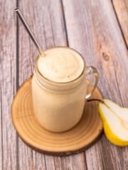 a pear smoothie with a straw