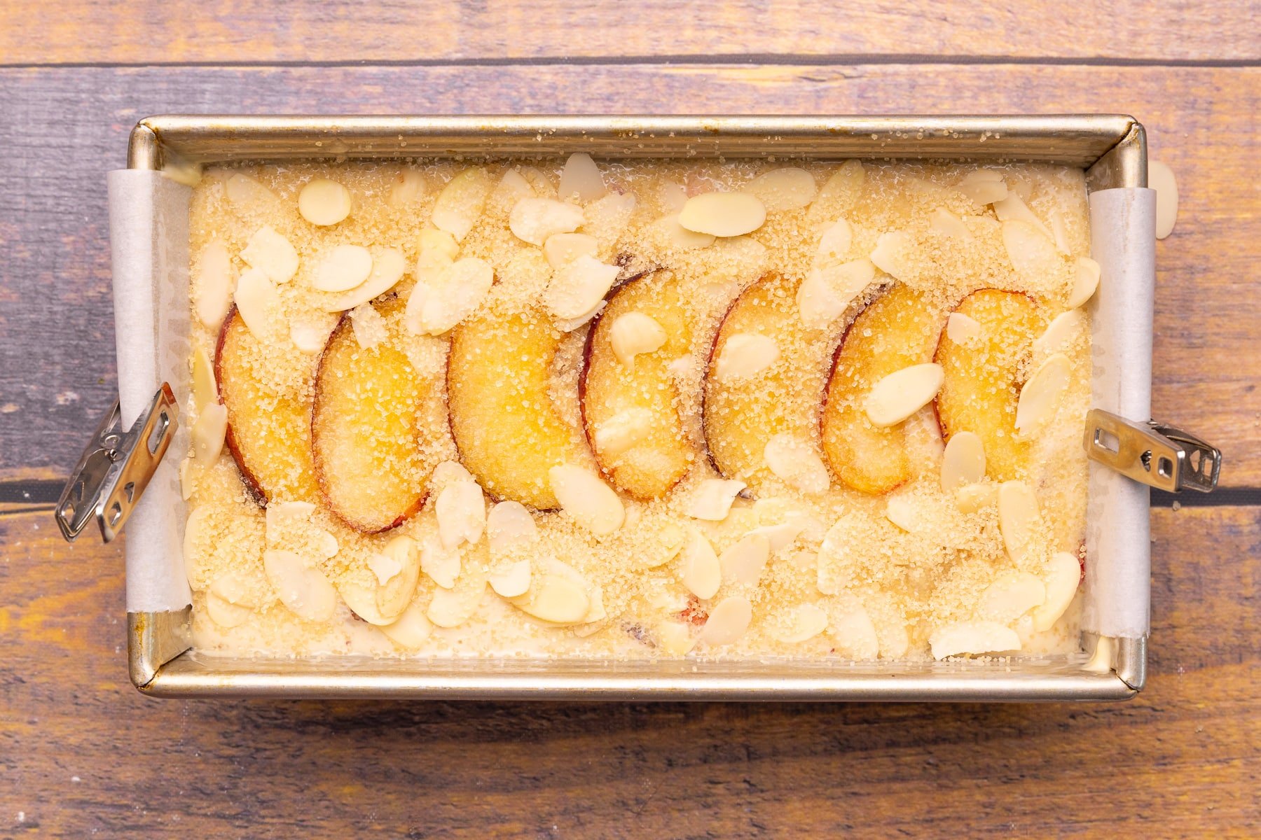 uncooked peach cake in a cake pan