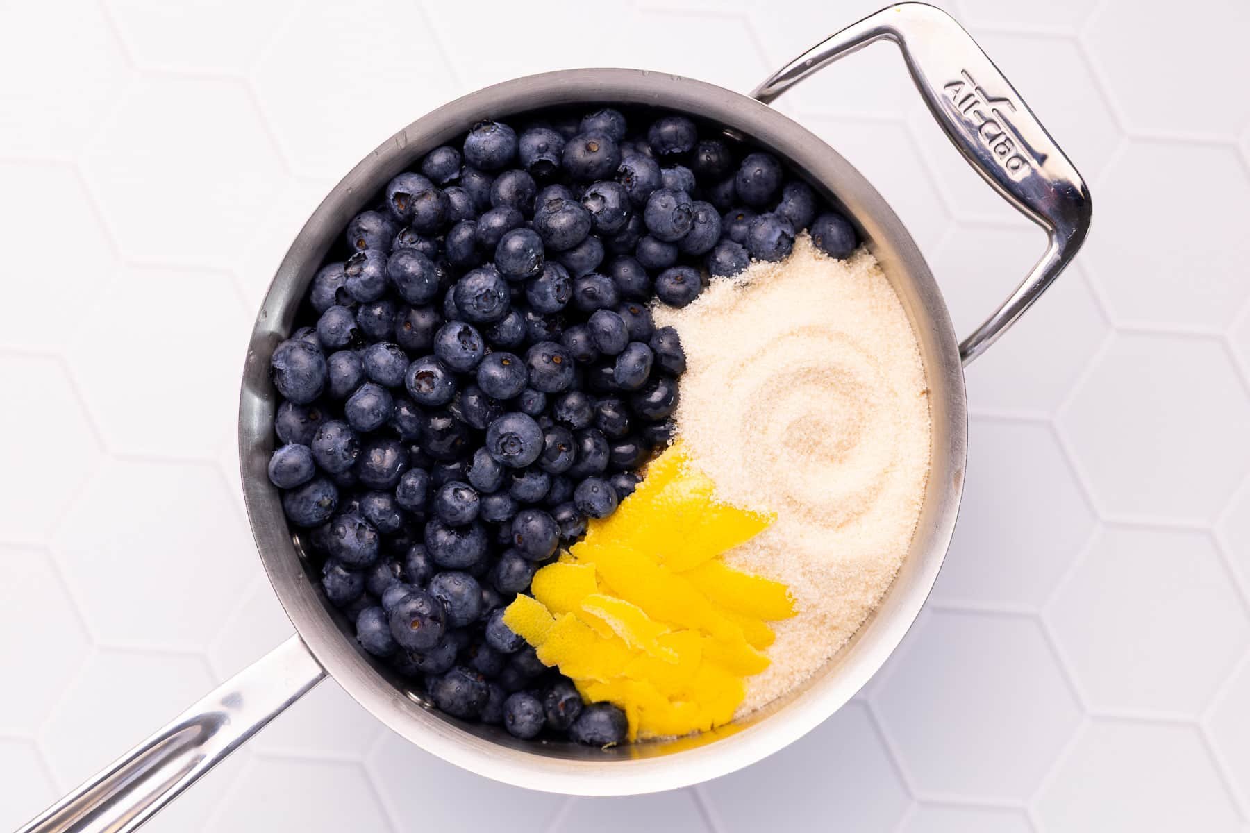 blueberries, sugar and lemon in a pan