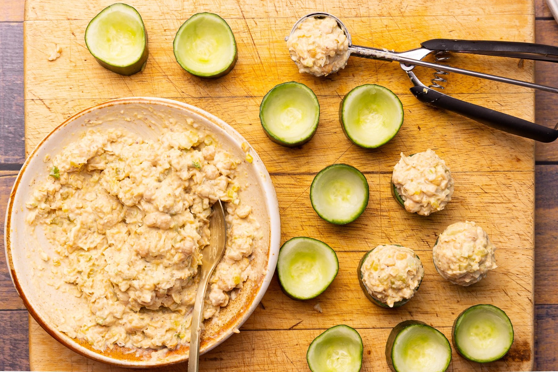 stuffing cucumber cups with chickpea salad