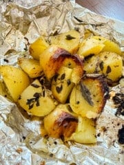 grilled potatoes and herbs in a foil packet
