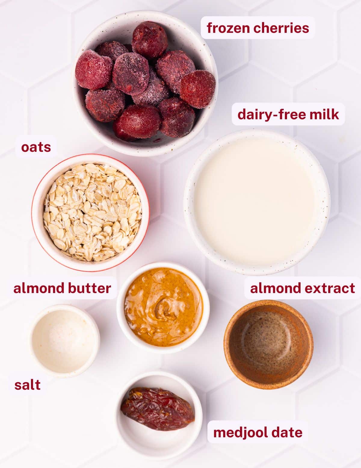 cherry smoothie ingredients - frozen cherries, oats, dairy-free milk, almond butter, salt, almond extract, medjool date,