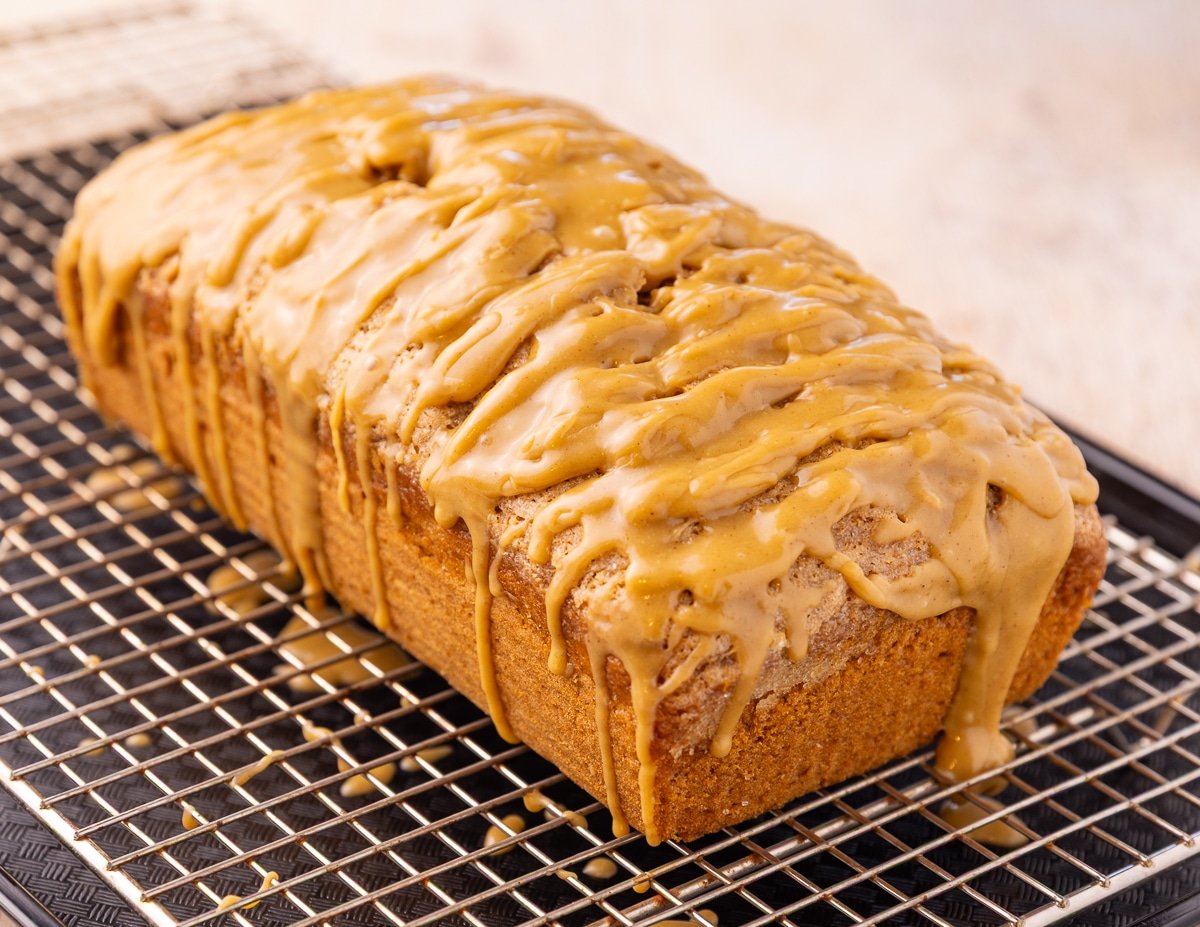 a drippy iced cake on a wire rack