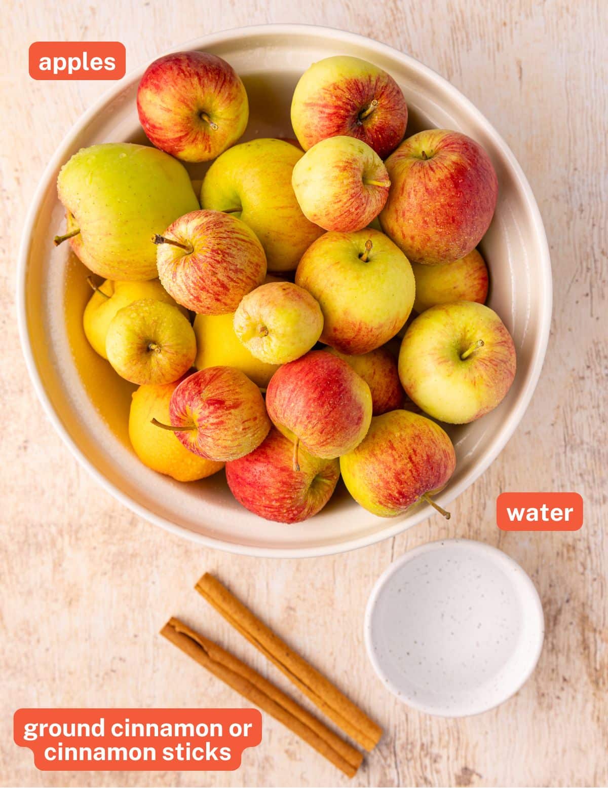 apples, water, and cinnamon sticks