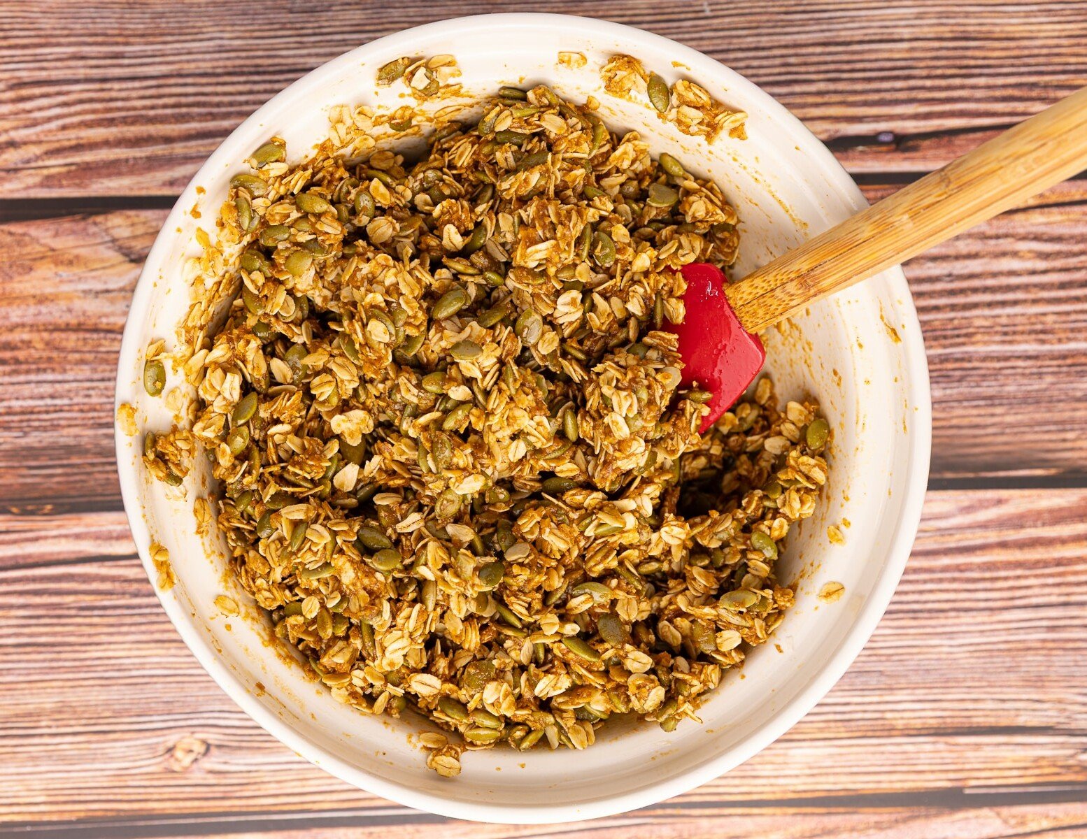 uncooked granola in a mixing bowl