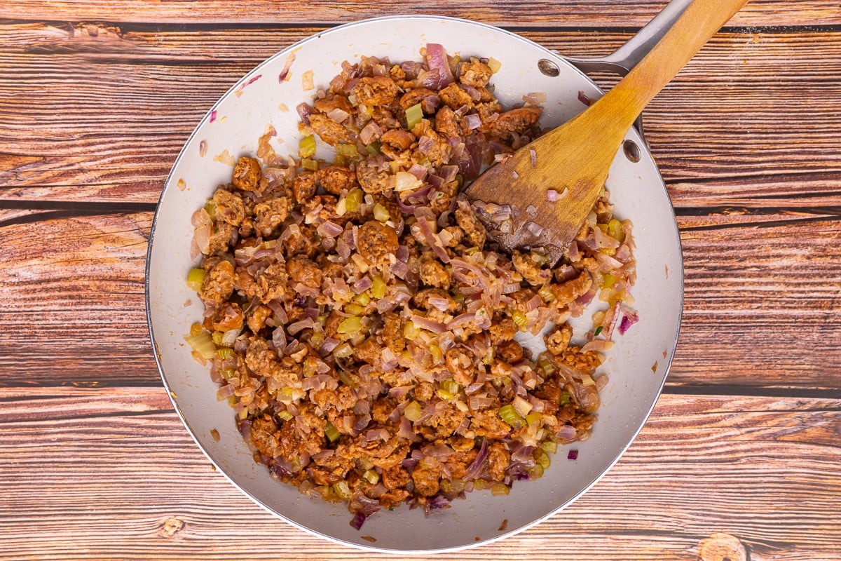 onion, garlic, celery, and sausage in a frying pan