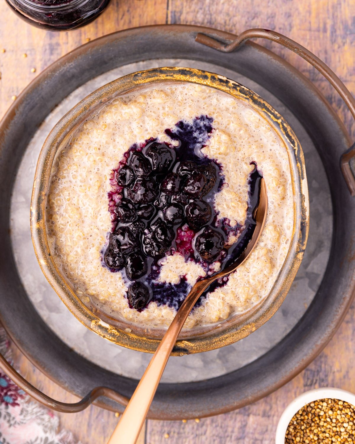 creamy quinoa pudding topped with blueberry compote