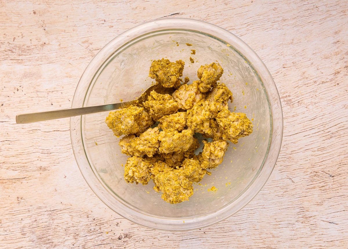 tempeh coated in seasonings in a bowl