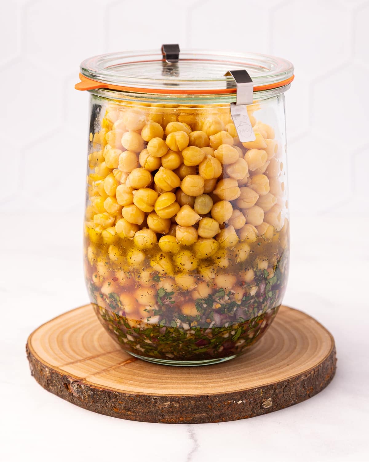 a jar of marinated chickpeas before mixing