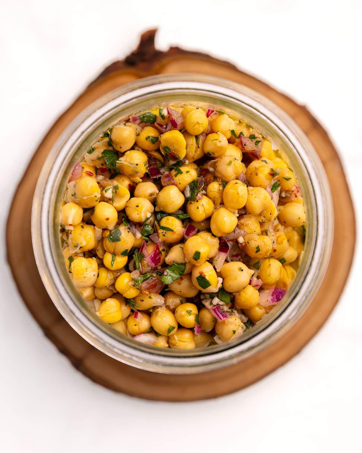 looking into a jar of marinated chickpeas from above