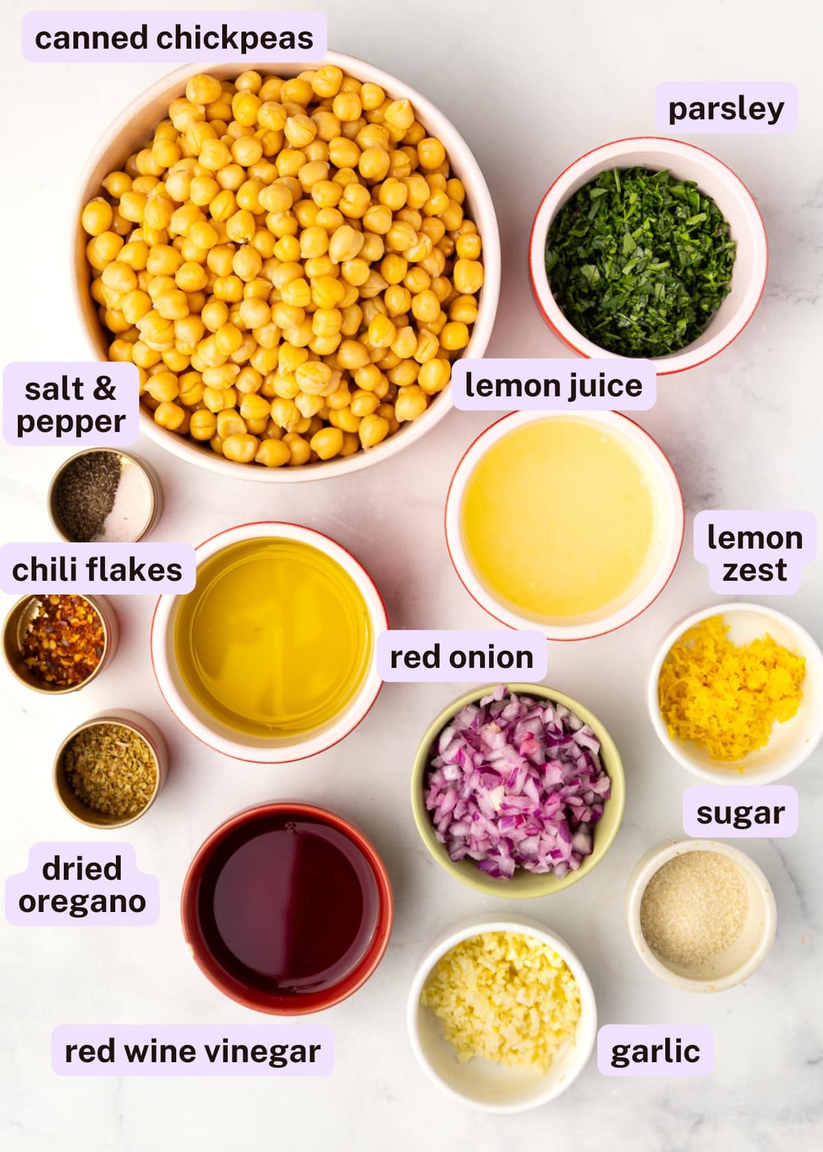marinated chickpea ingredients: chickpeas, parsley, salt and pepper, olive oil, lemon juice, lemon zest, chili flakes, oregano, red onion, garlic, red wine vinegar.