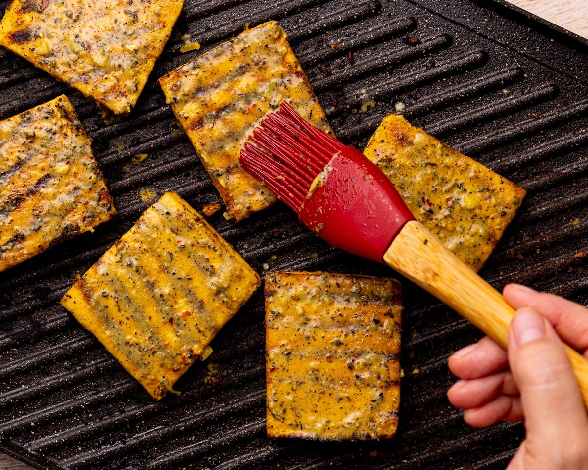 brushing marinade on grilled tofu