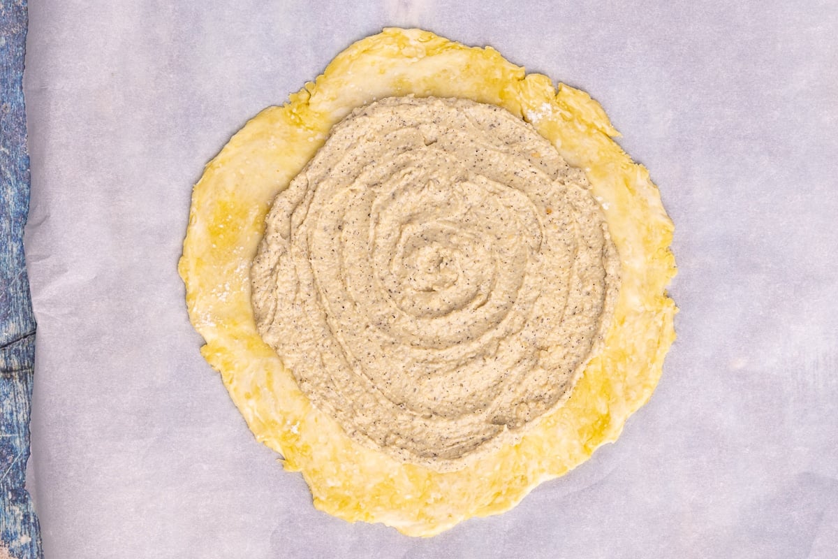 rolled out pie crust with herby cashew cream spread on it