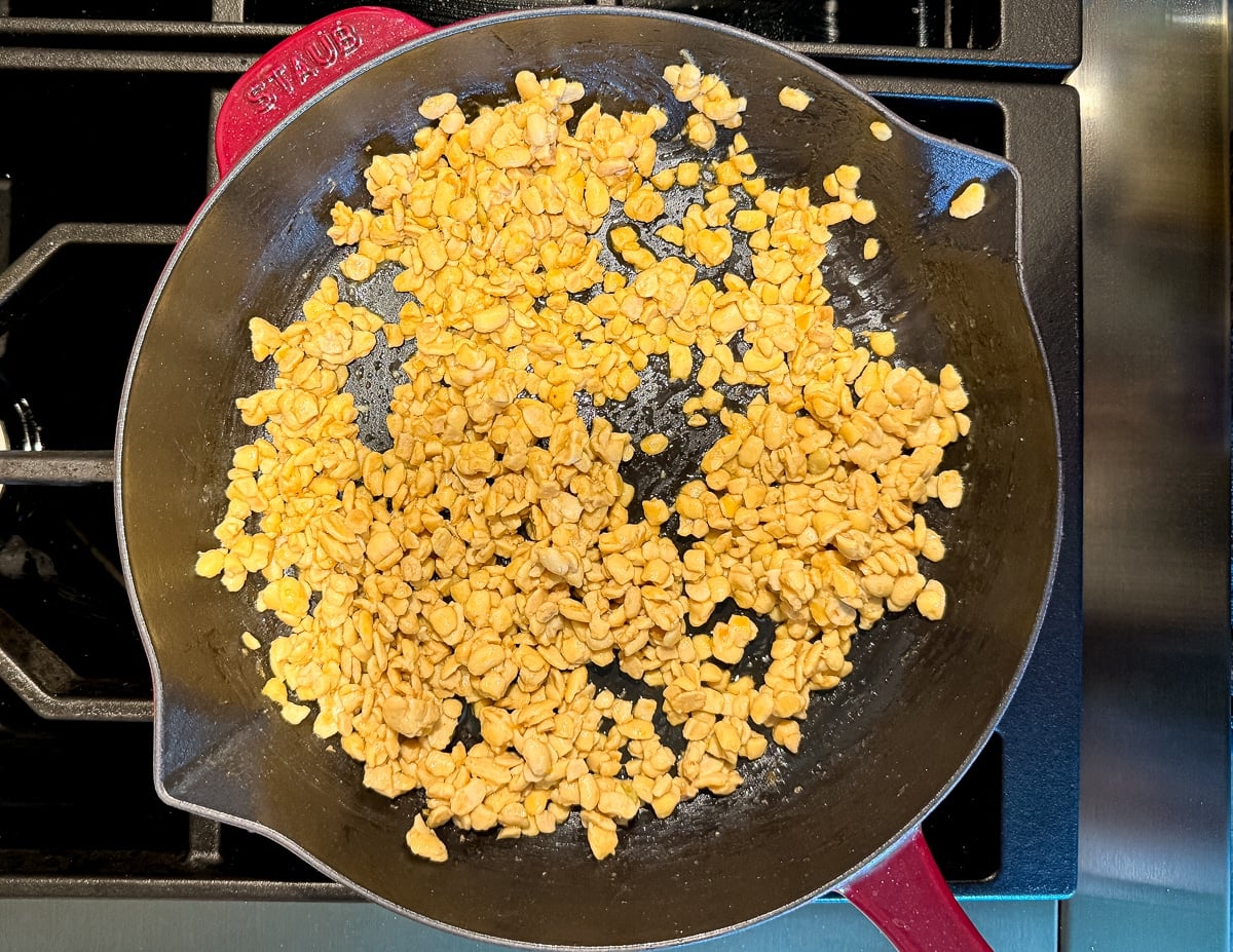 crumbled tempeh frying in a pan