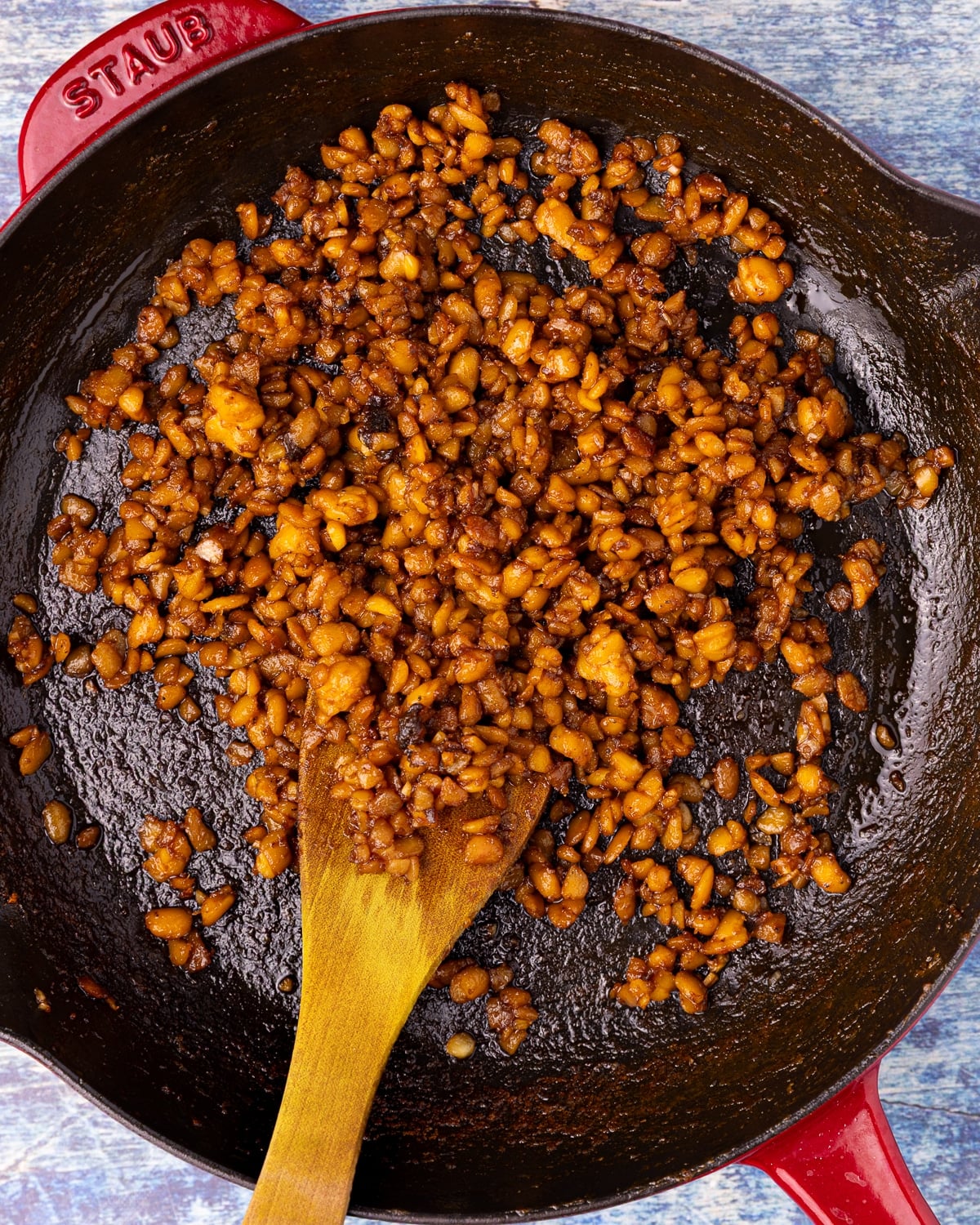 sticky crumbled tempeh in a skillet
