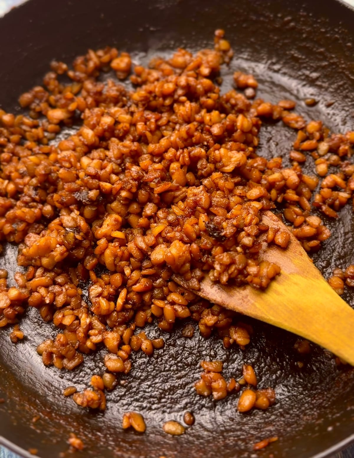 sticky crumbled tempeh in a pan 